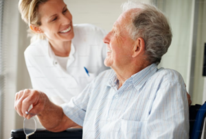 Caregiver assisting smiling senior man with support and companionship at home, home care Schaumburg, IL
